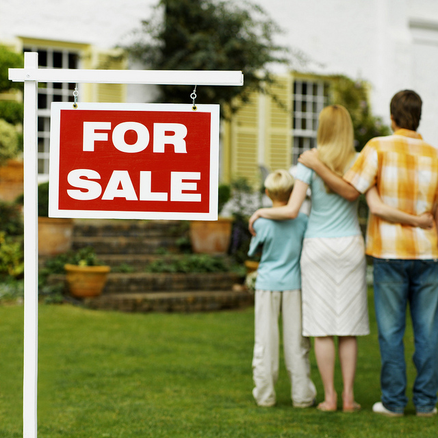 Family with For Sale Sign