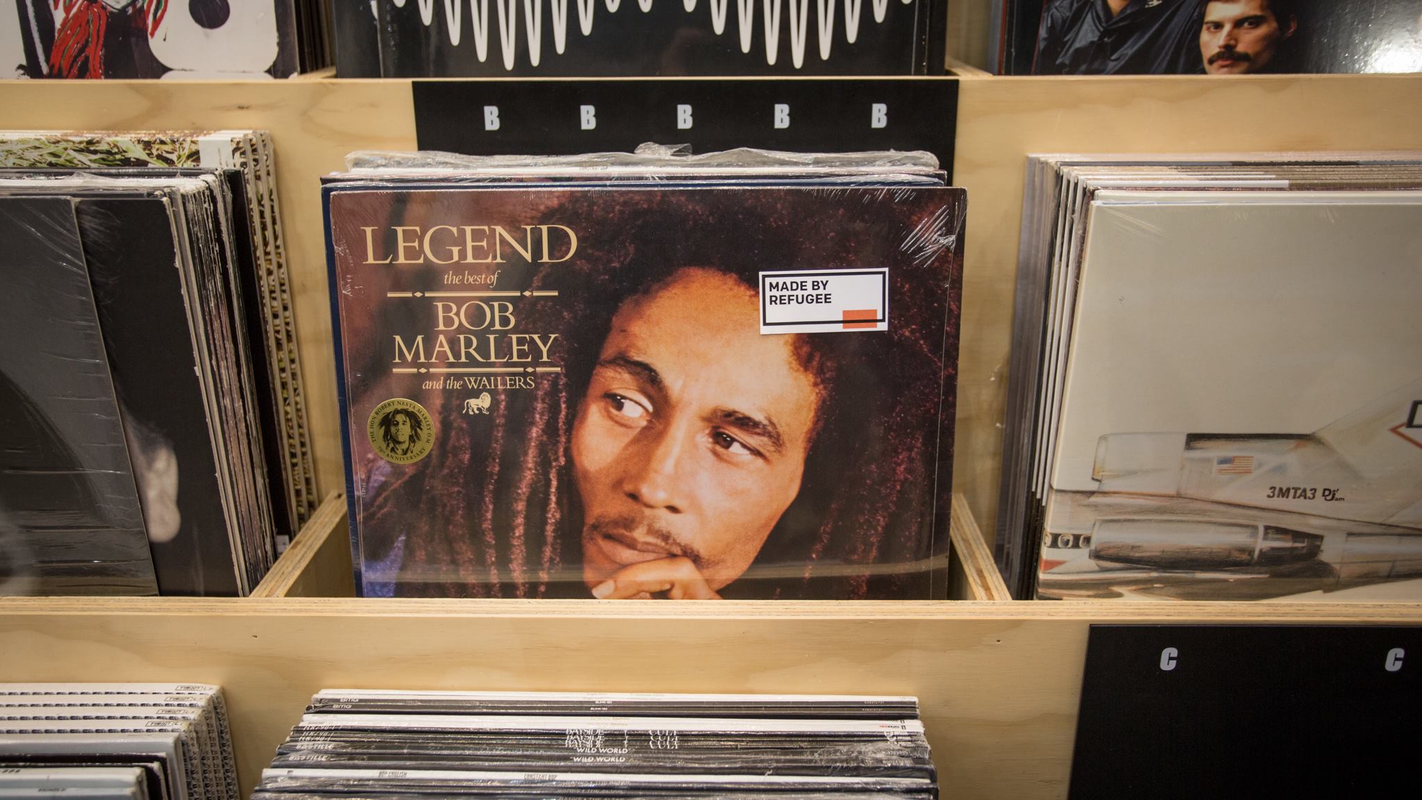 Photo of Bob Marley album with "Made by Refugee" sticker