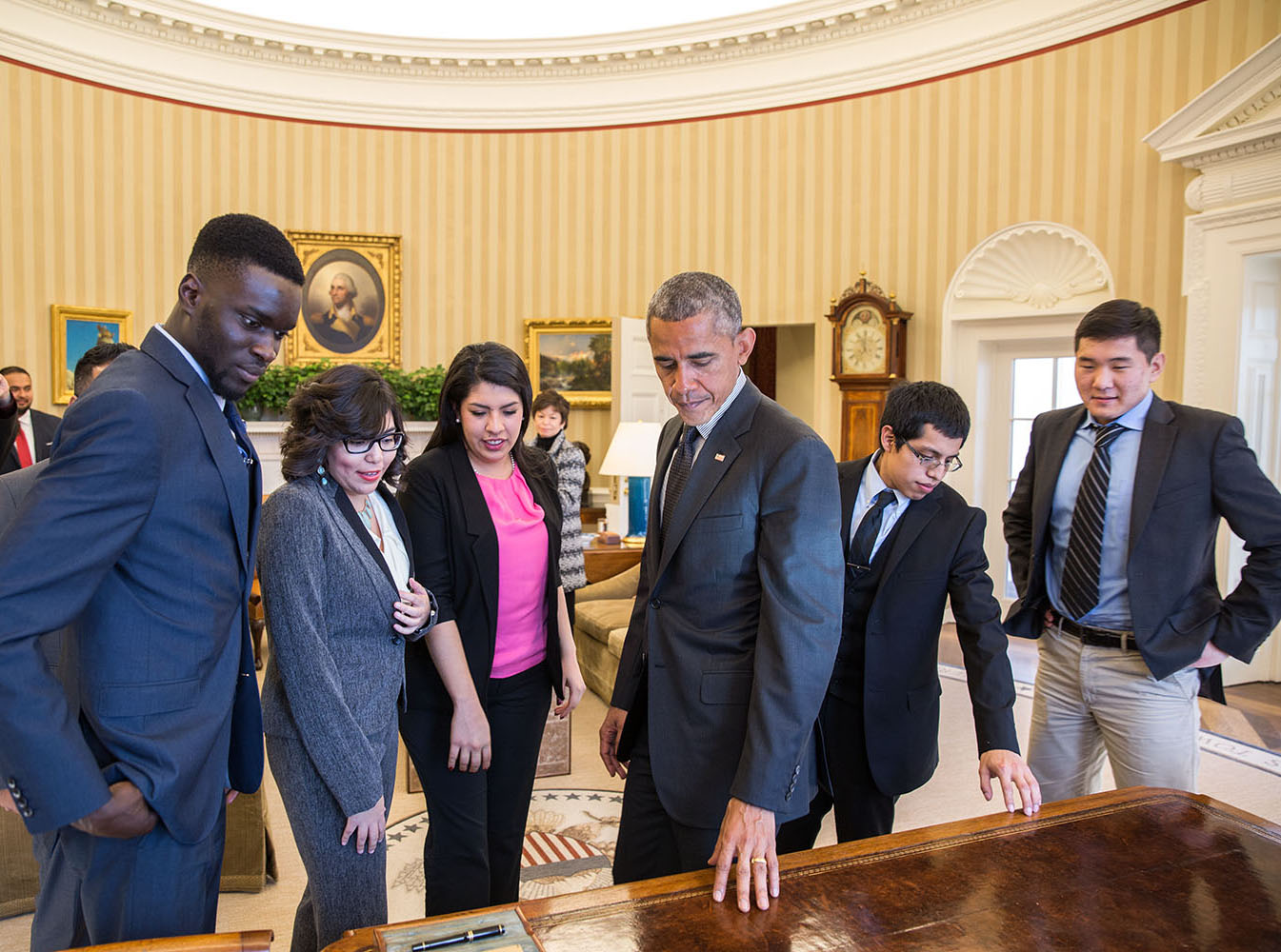 President Barack Obama shows the Resolute Desk to a group of DREAMers, following their Oval Office meeting in which they talked about how they have benefited from the Deferred Action for Childhood Arrivals (DACA) program, Feb. 4, 2015. (Official White Hou