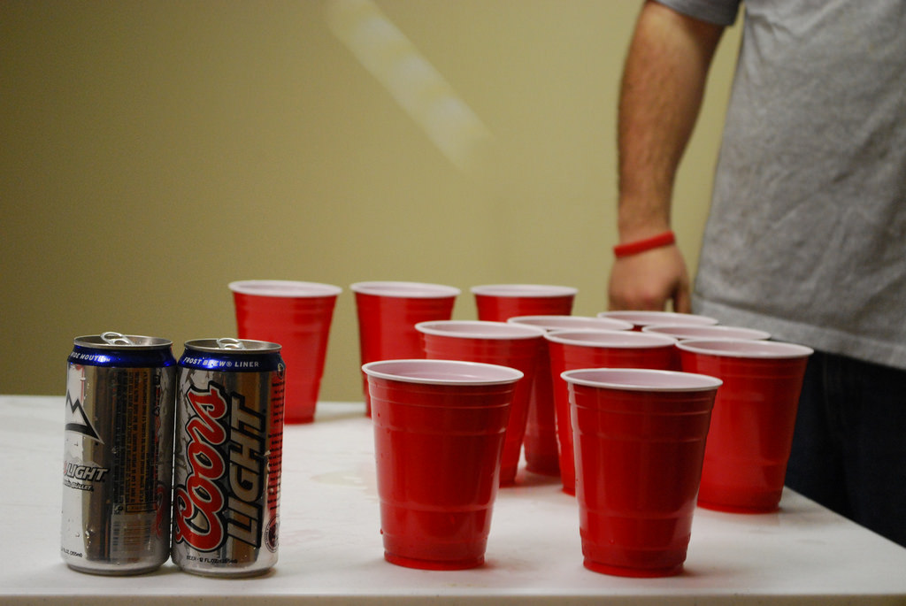 a photo of red solo cups and beer cans