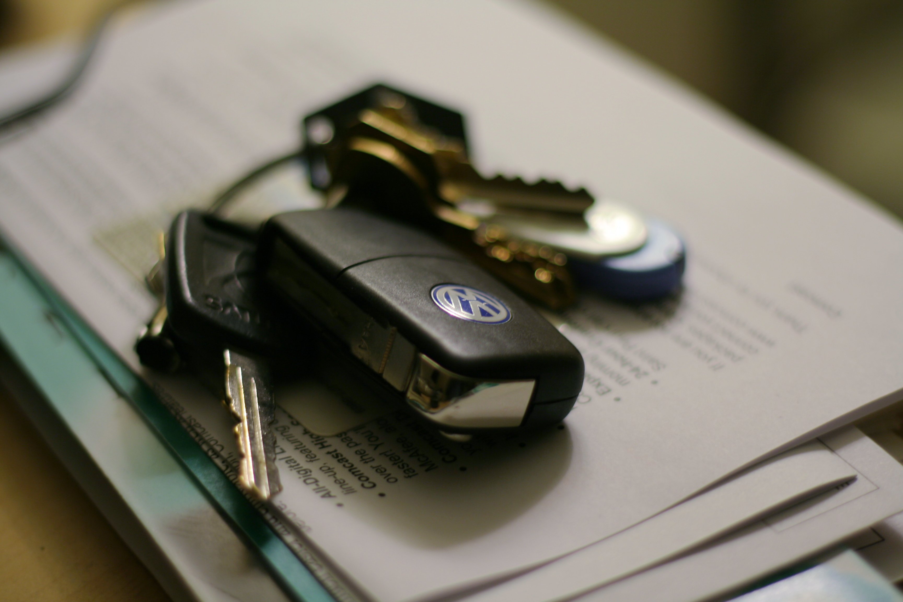 Volkswagen key on a table and paper