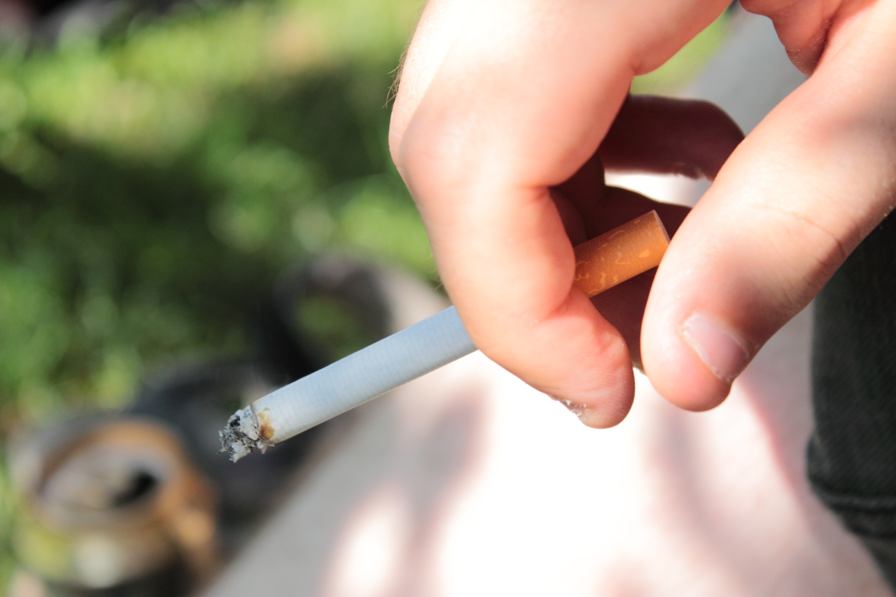 photo of a hand holding a cigarette 