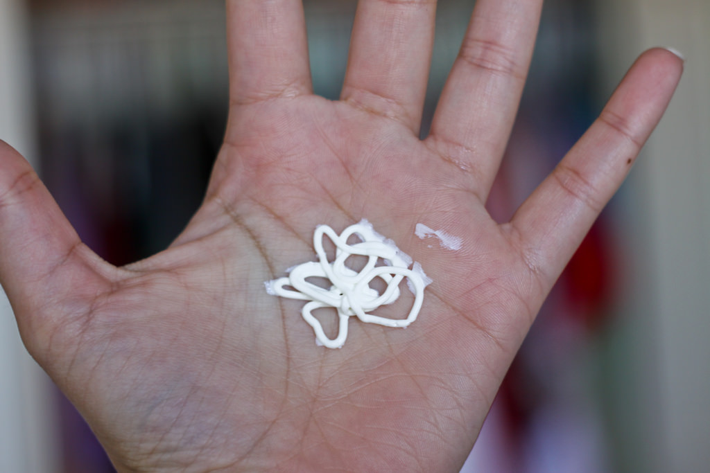 sunscreen in a person's hand