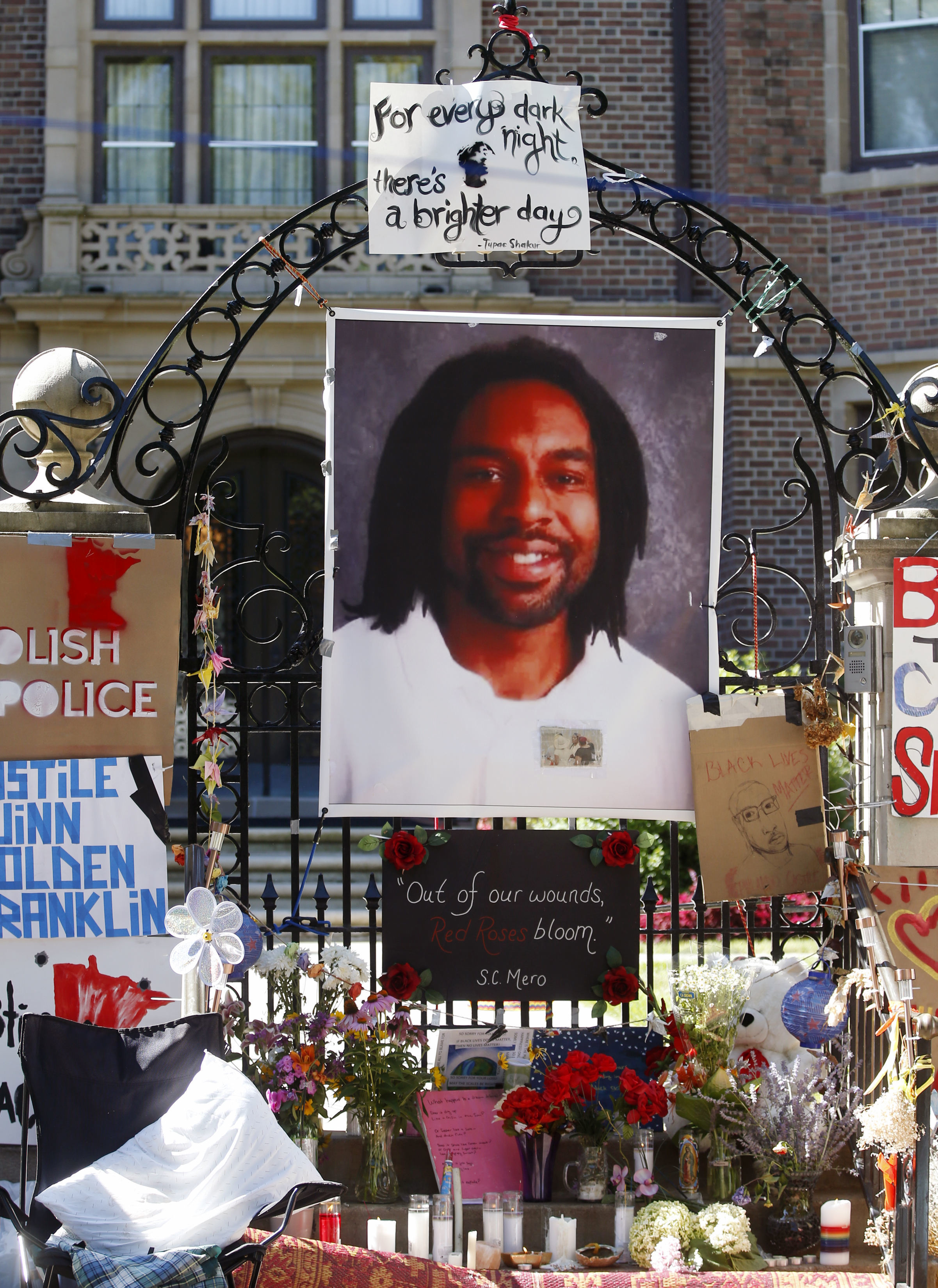 "In this July 25, 2016, file photo, a memorial including a photo of Philando Castile adorns the gate to the governor's residence ..."