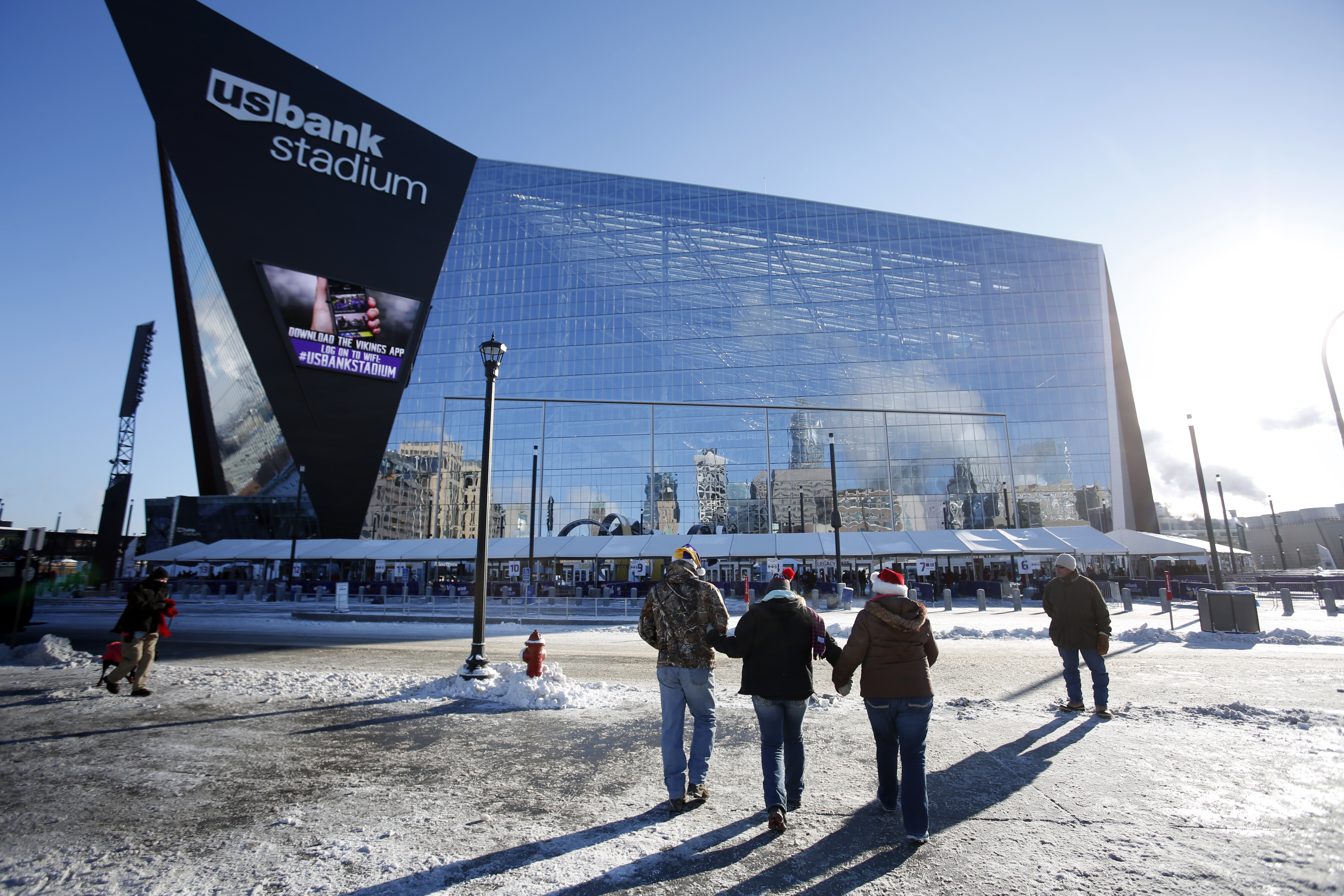 Fans walk to the Minnesota Vikings U.S. Bank Stadium before a game against the Indianapolis Colts.