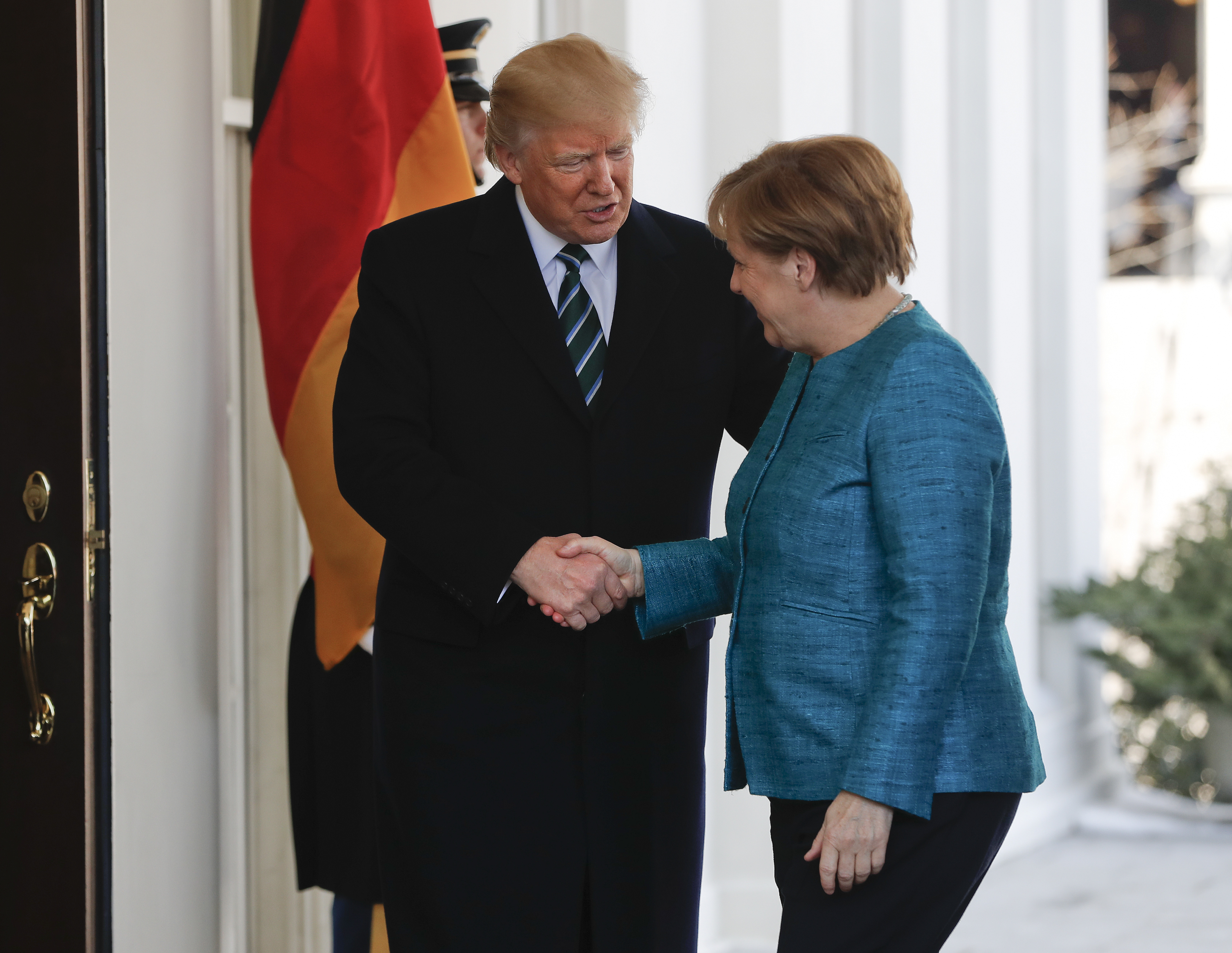 Trump shaking Merkel's hand