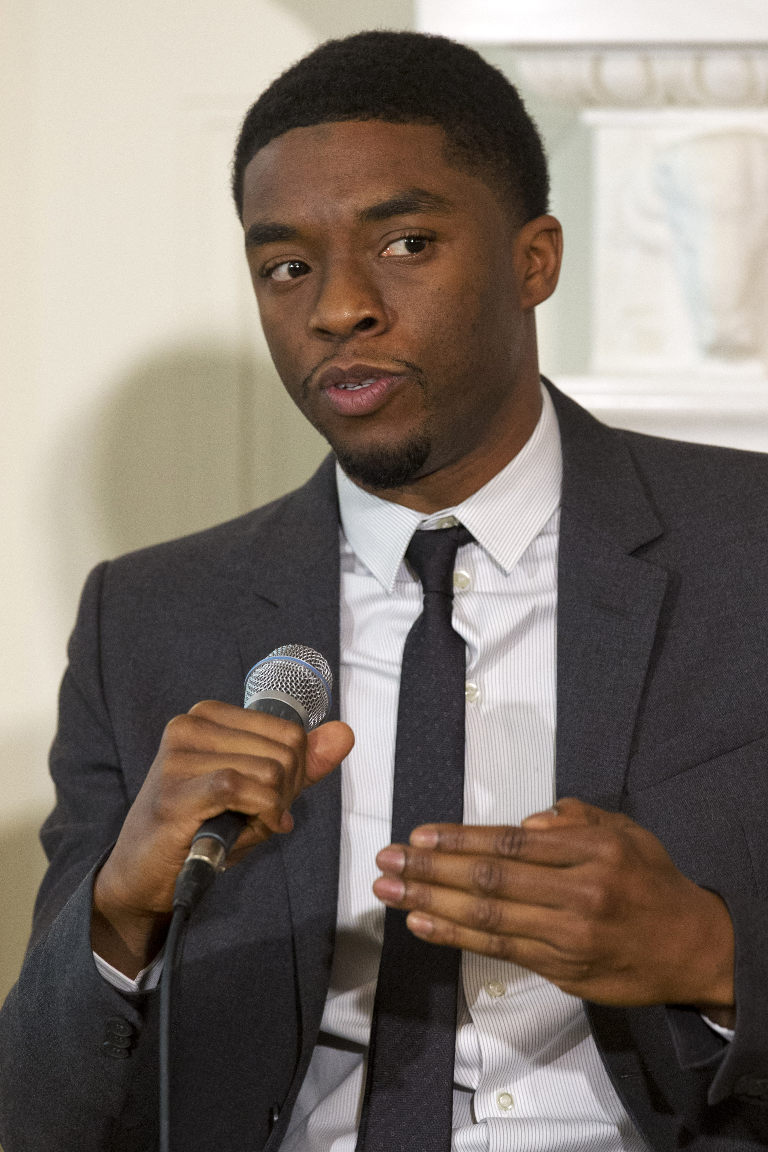 Chadwick Boseman speaking on a panel hosted by Michelle Obama in 2013. 