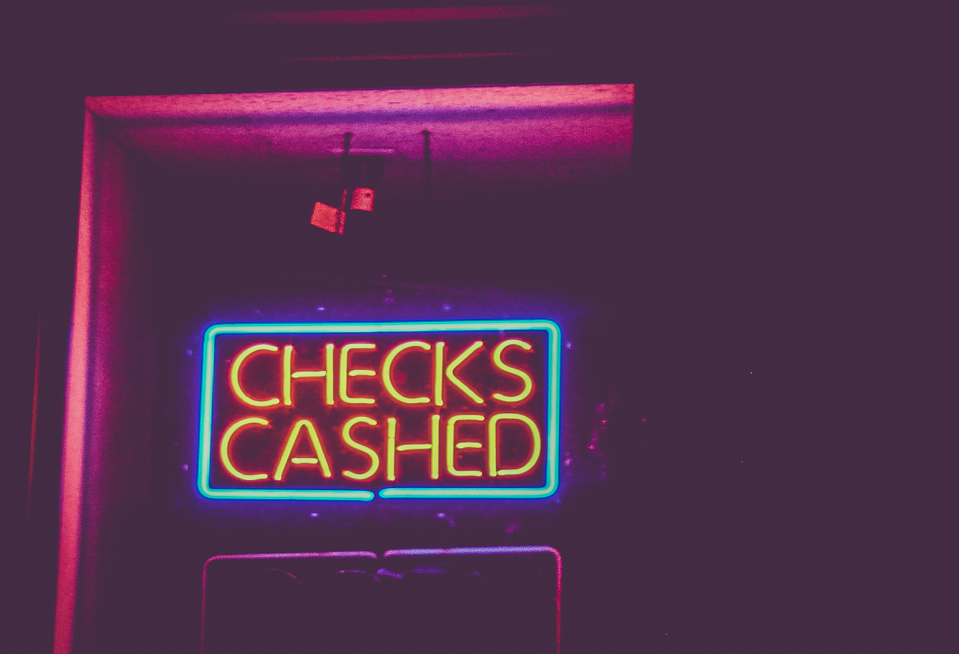 checks cashed sign at night