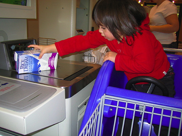 Child using self-checkout.