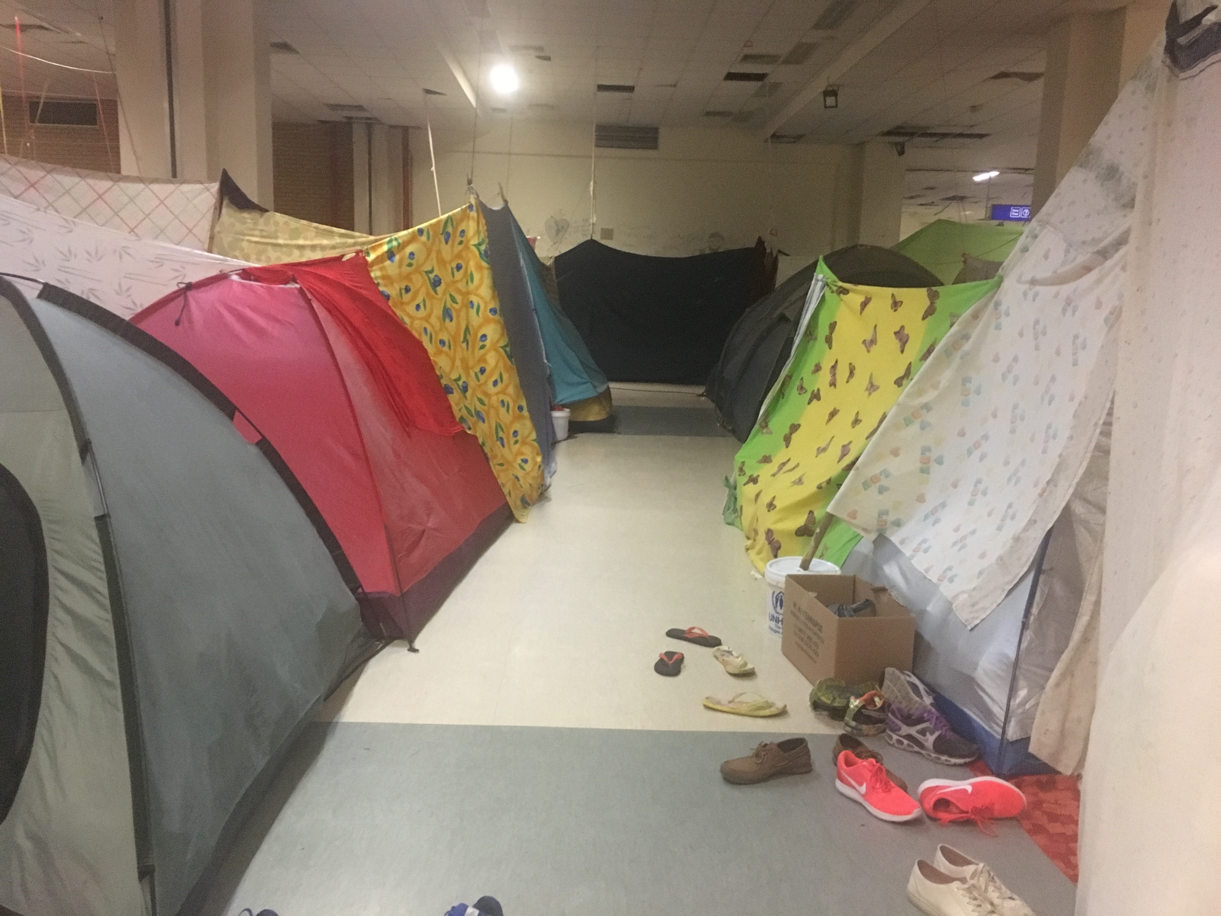 Shoes line a row of tents at Elliniko Airport