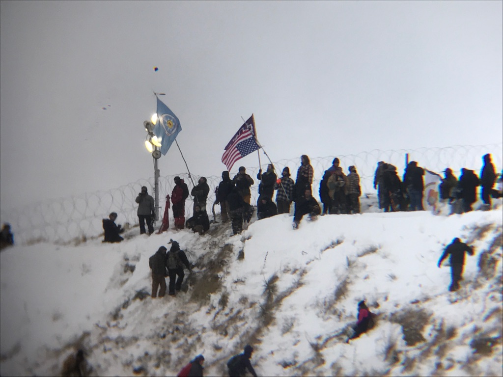 Protesters plant a flag on Turtle Hill. 