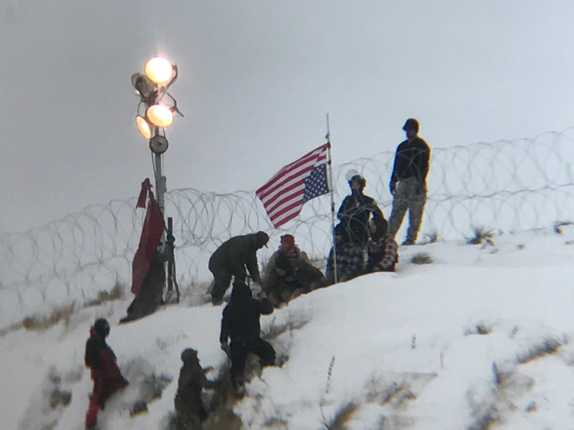 Protesters plant a flag on Turtle Hill. 