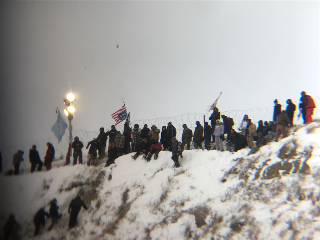 Protesters plant a flag on Turtle Hill. 