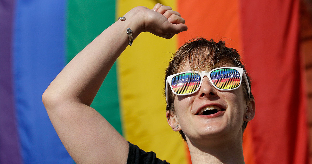 person-in-front-of-pride-flag