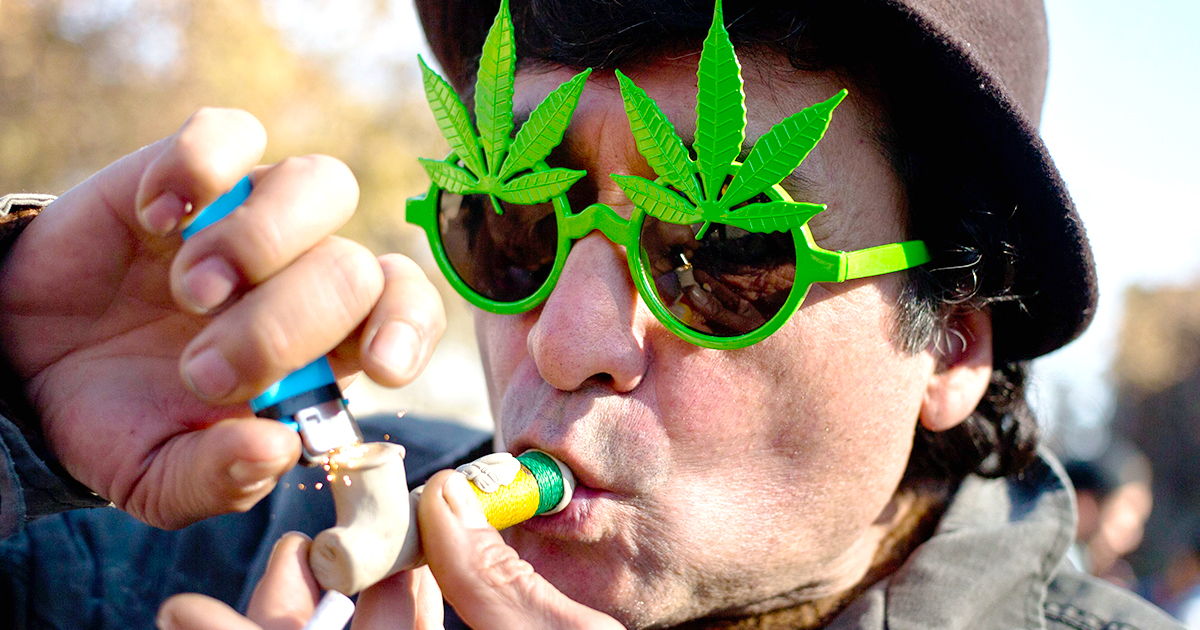 man-wearing-marijuana-leaf-sunglasses-smoking-marijuana
