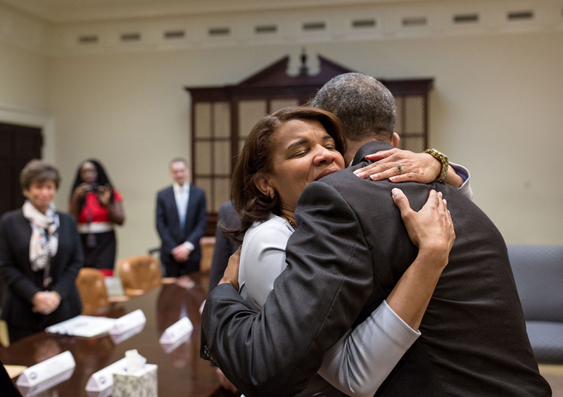 "President Barack Obama hugs Kemba Smith during a greet with formerly incarcerated individuals who have received commutations, in the Roosevelt Room of the White House, March 30, 2016."