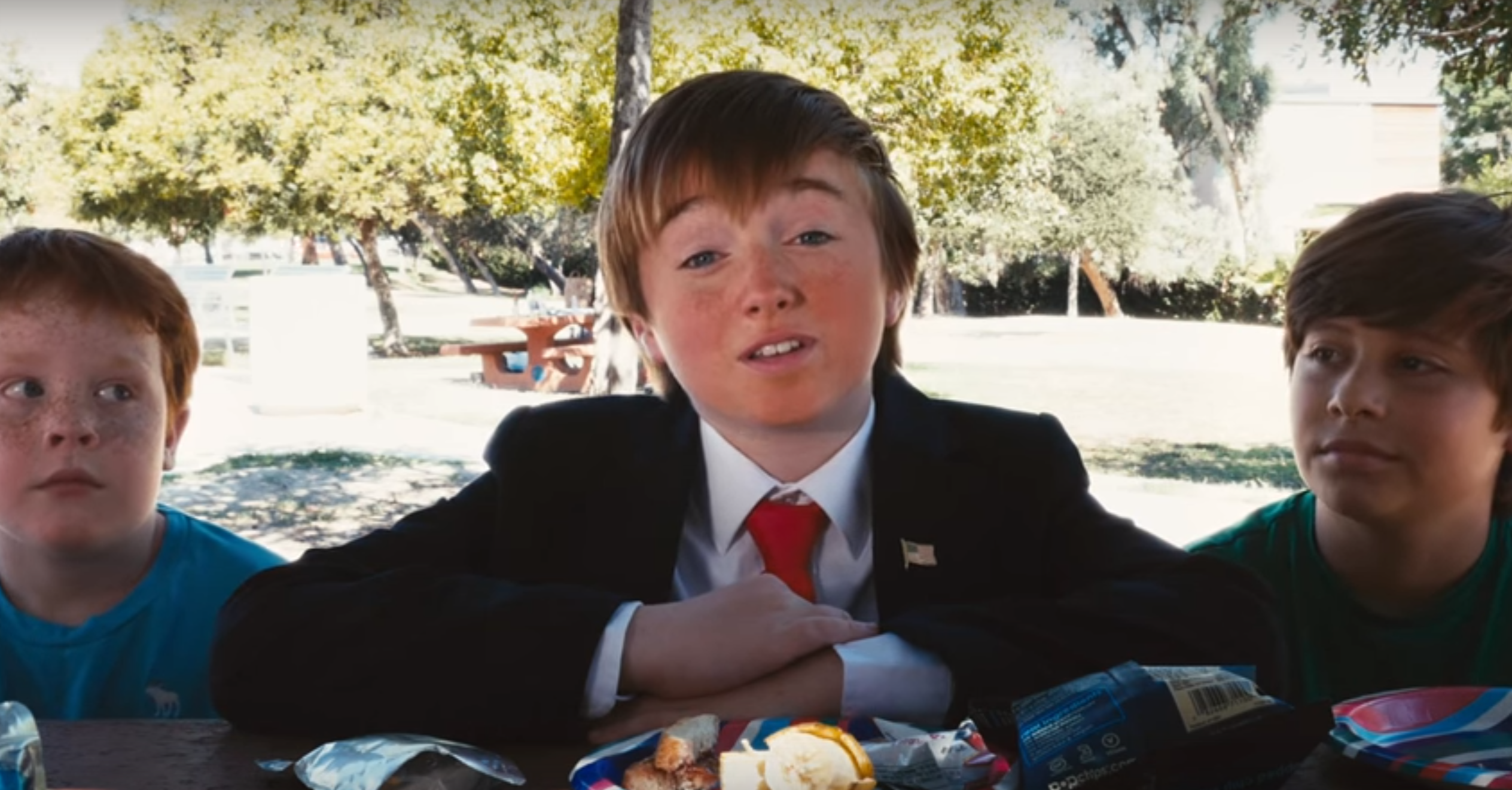 Trump Kid argues his policies over peanut butter and jelly sandwiches. 