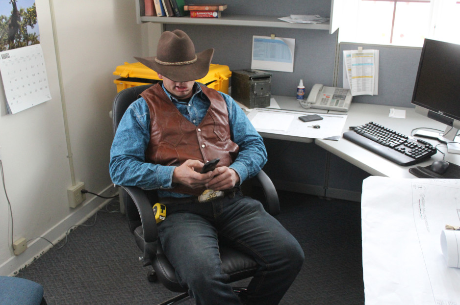 Ryan Bundy sits near a bank of computers in a government-owned building