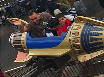 Alaa Alamour on a ride at Disneyland with his kids