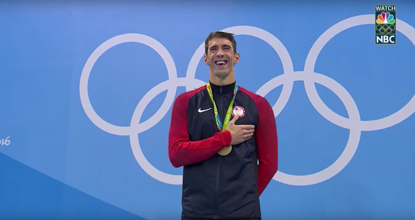 Michael Phelps laughs during his gold medal ceremony.