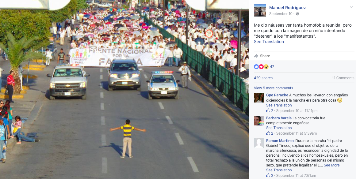 A boy stands in front of anti-gay protesters Celaya in the Mexican state of Guanajuato.