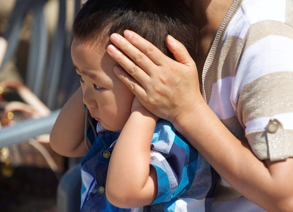 Boy covers ears