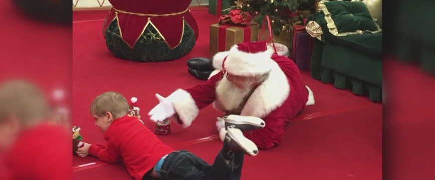 Caring Santa on the ground with boy