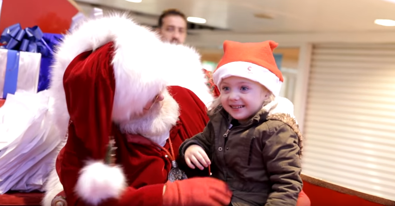 Santa signs with little girl who has hearing problems