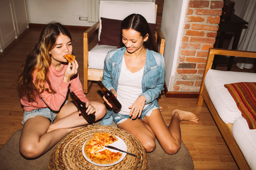 Two girls enjoying pizza time together