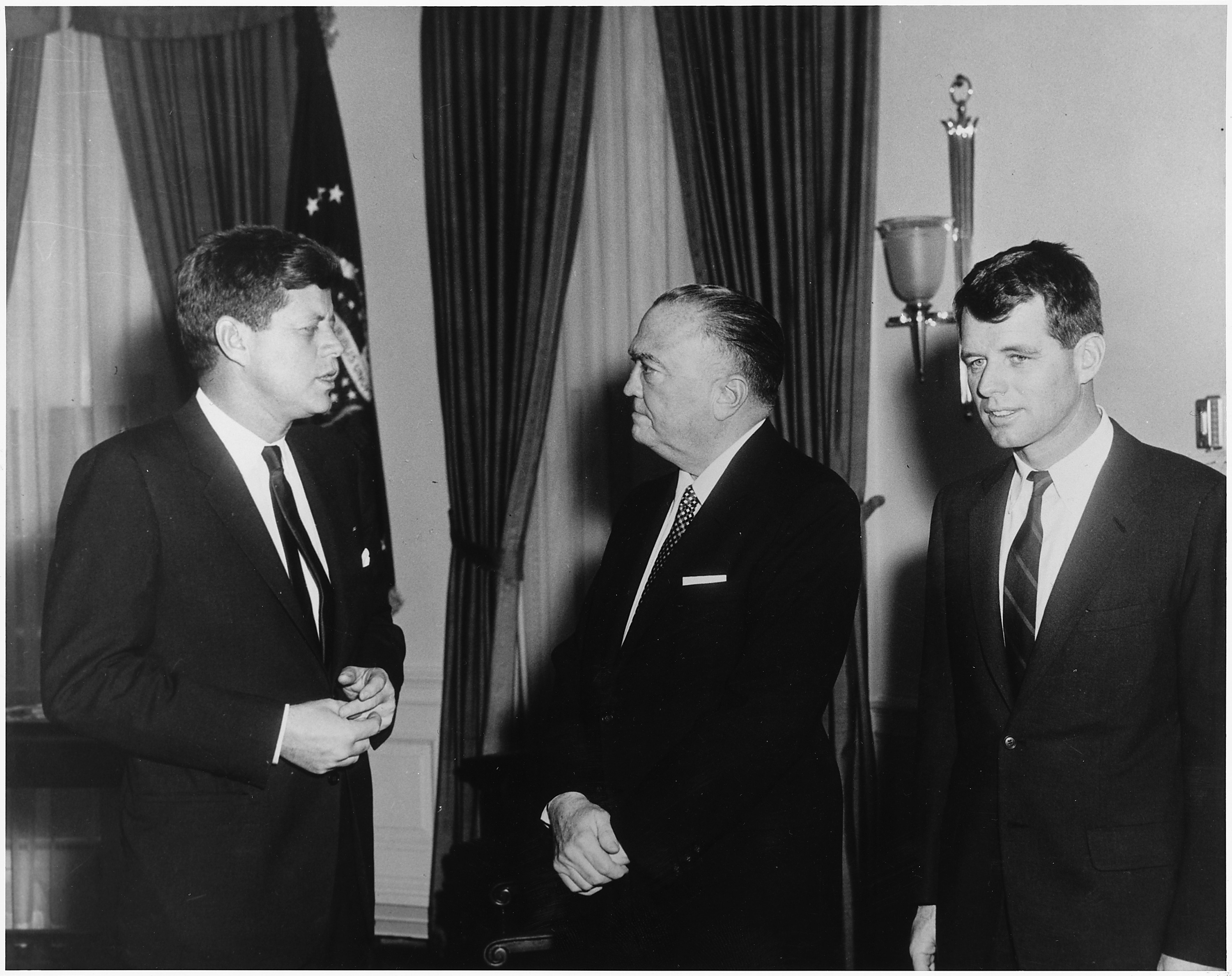 J. Edgar Hoover, pictured in the middle, meets with President John F. Kennedy on the left and Attorney General Bobby Kennedy on the right in 1961.