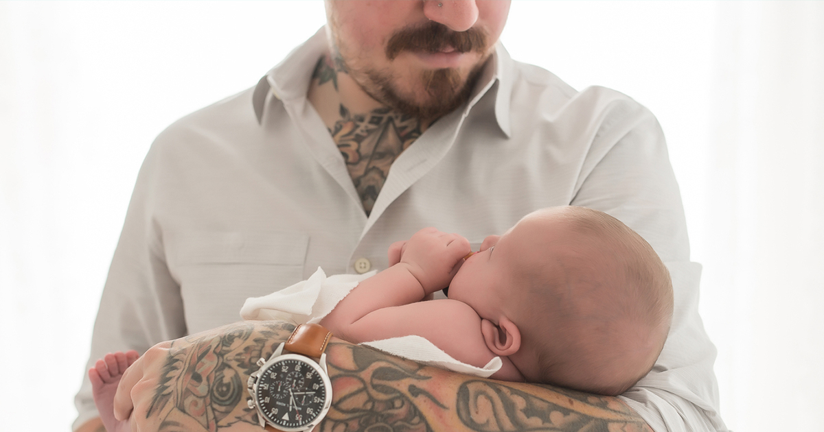 tattooed-man-holding-baby-daughter