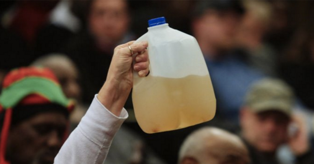 hand-holding-bottle-brown-water