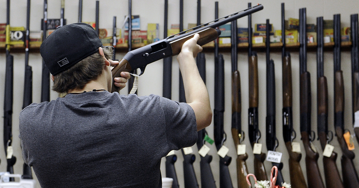 man-looking-at-gun-in-gun-store