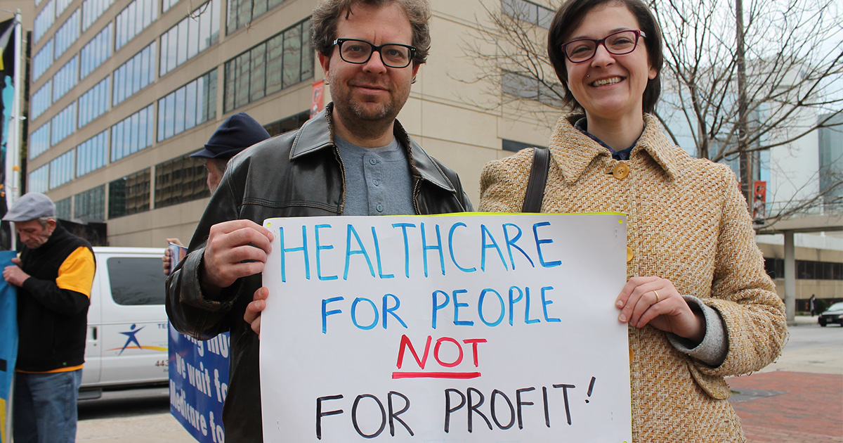 two-people-holding-health-care-sign