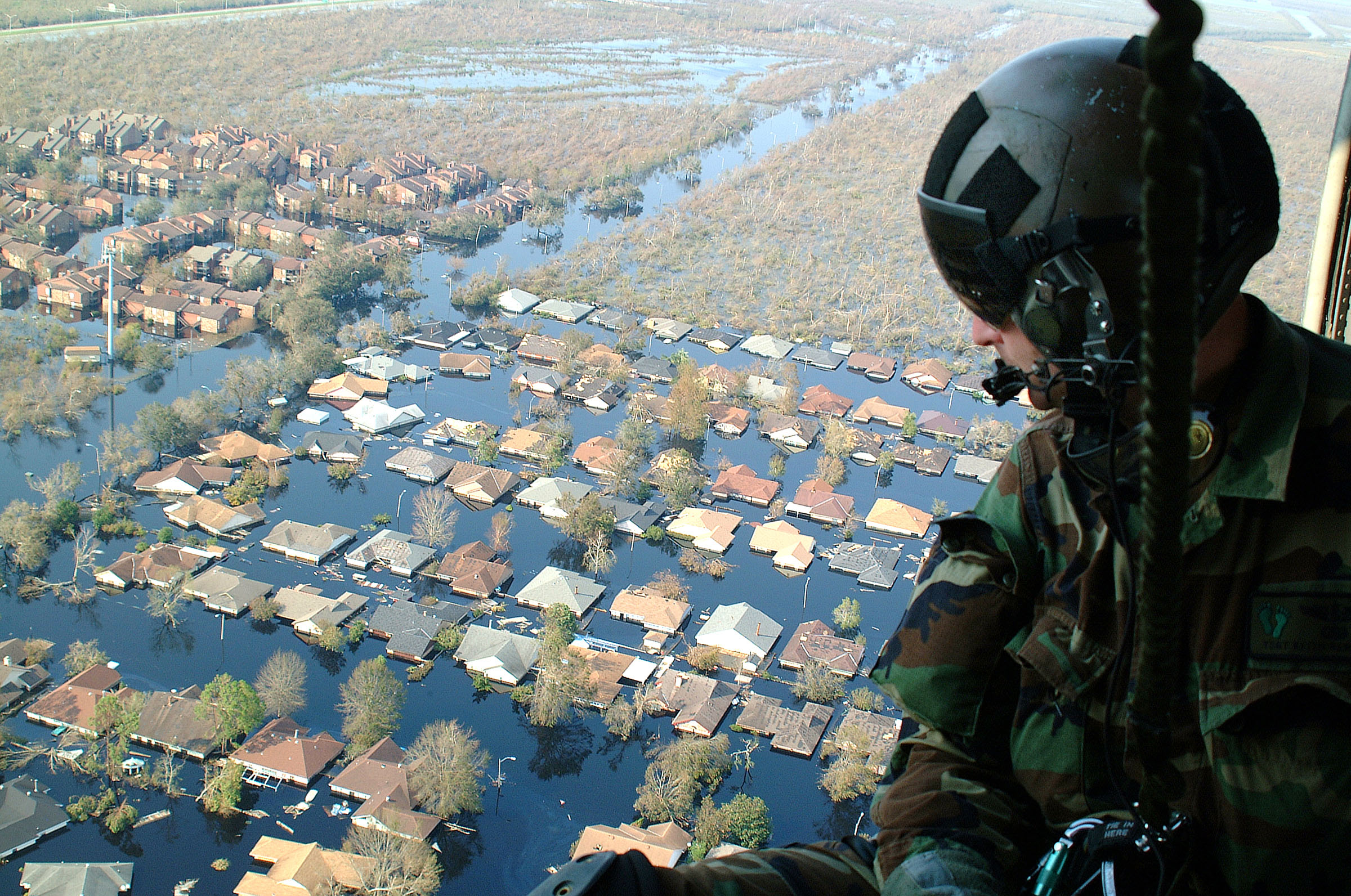 The U.S. Airforce flies over flooded neighborhoods after Hurricane Katrina. 