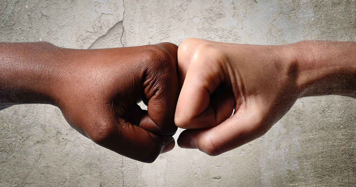 black-skinned-knuckles-pounding-white-skinned-knuckles