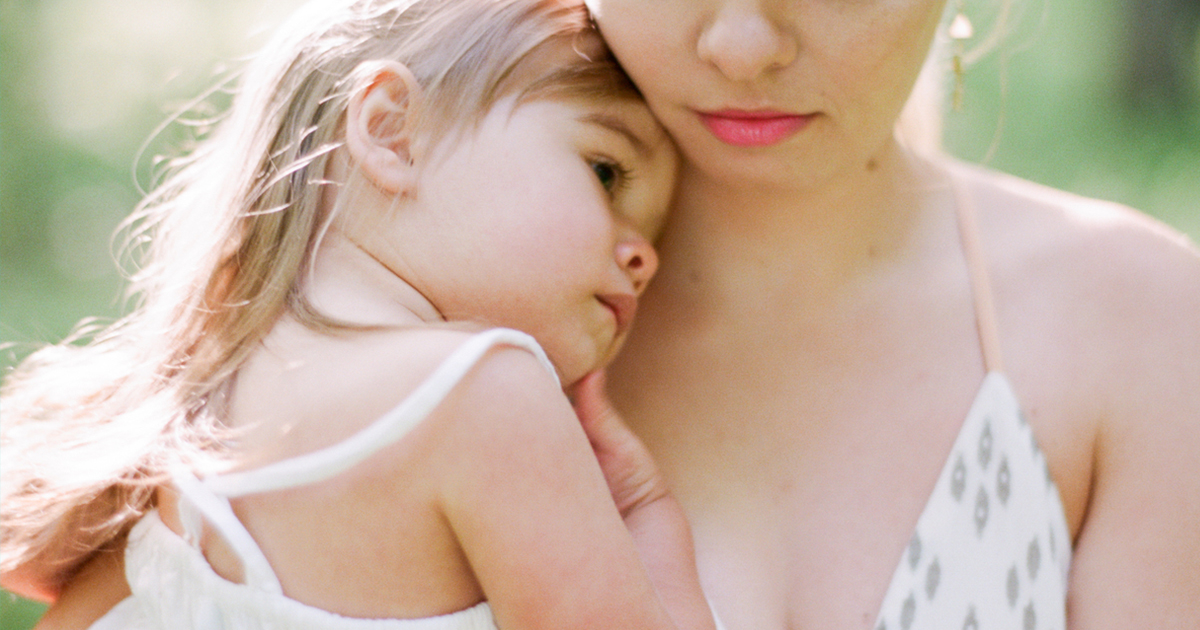 woman-holding-hugging-little-girl