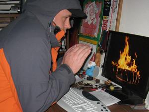 Man in a cold office on his computer